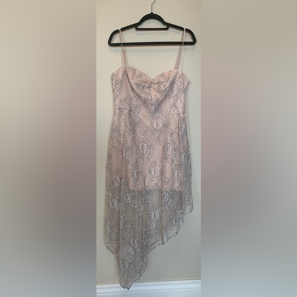 Asymmetrical dress with a cream color and floral pattern on the outside.